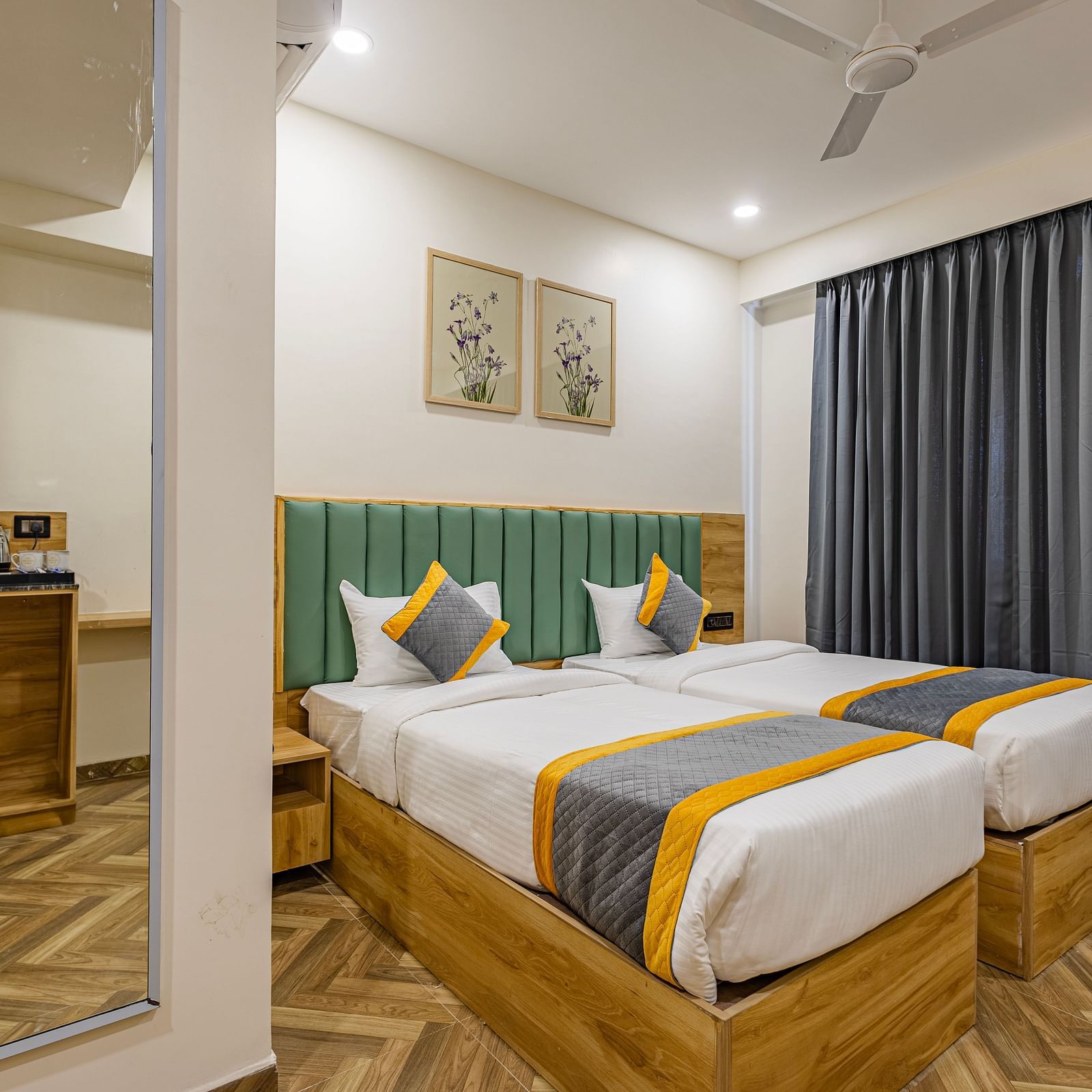 Lemonridge Hotels, KPHB | Hotel room with two beds, side table, and a window with curtains. Simple and functional.